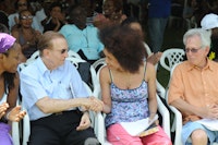 Poet Staceyann Chin shaking hands with former Jamaican Prime Minister Edward Seaga at the Calabash International Literary Festival. Photo by Collin Reid.