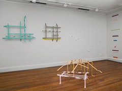 Installation view, Tape and Steel: Sculpture and Tape Drawings by Rebecca Smith (2010). Foreground shows “Pink House” (2009) and “Orange Animal” (2009).