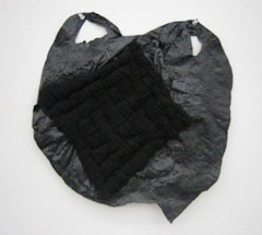 Josh Blackwell “Untitled (corked),” (2010) plastic bag, organic yarn, 16 1/2 x 15 1/2 inches.