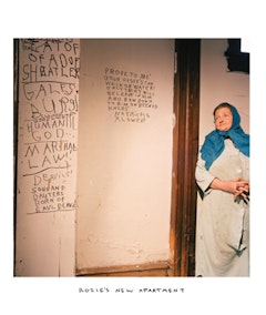 “ROZIE’S NEW APARTMENT” (2005). Chromogenic print with handwritten caption in oil. 36 x 30 inches, edition of 6 + 2 AP. Image courtesy Postmasters Gallery, New York.