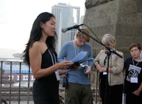 Brooklyn Poet Laureate Tina Chang reads on the Brooklyn Bridge on the Poets House Poetry Walk, 2010. Photo by David St.-Lascaux.
