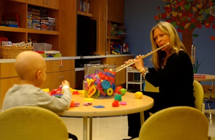Flutist, doing a Music That Heals program for a children’s out-patient unit. Photo courtesy of Kathy Nicolosi. 
