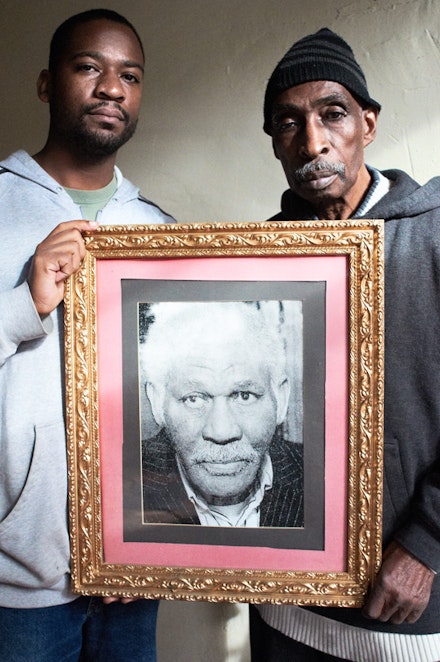 <i>Local activist named Ted (left) and Clarence Hardy (right), holding a photo of Judge John Phillips, founder of the Slave Theater (November 2011).</i>