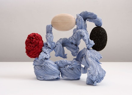 John Newman, “Fitting disks in powder blue,” 2010, extruded aluminum, pumice stone, wood, handmade
Laotian paper, starch, acrylic paint, stove-blacking, 10 ½ x 12 x 6”. Courtesy Tibor de Nagy Gallery, New York.