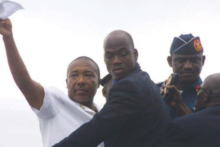 Charles Taylor waving farewell as he stepped on the plane leaving Liberia in 2003. Photo by permission of Pewee Flomoku.